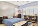 Bedroom with blue coverlet, neutral walls, shuttered windows, and decorative storage at 13849 S 179Th Ave, Goodyear, AZ 85338