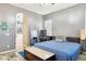 Bedroom with blue coverlet, neutral walls, shuttered windows, and view of attached bathroom at 13849 S 179Th Ave, Goodyear, AZ 85338