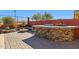 Outdoor kitchen featuring a stone fire pit, bar top, and gas grill at 13849 S 179Th Ave, Goodyear, AZ 85338