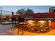 Outdoor kitchen area with a stone countertop, bar seating, and a built-in grill at 13849 S 179Th Ave, Goodyear, AZ 85338