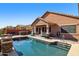 Backyard pool with patio, covered seating area, and outdoor kitchen at 13849 S 179Th Ave, Goodyear, AZ 85338