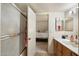 Cozy bathroom with a vanity and a sink, a shower/tub combination, and a view into the bedroom at 1402 E Guadalupe Rd # 145, Tempe, AZ 85283