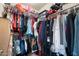 Spacious walk-in closet filled with an extensive collection of clothing and accessories at 1402 E Guadalupe Rd # 145, Tempe, AZ 85283