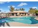 Community pool surrounded by lush landscaping and seating areas for relaxation at 1402 E Guadalupe Rd # 145, Tempe, AZ 85283