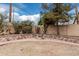 Private backyard featuring a stone fire pit, block wall, and desert landscaping at 14404 N 56Th Pl, Scottsdale, AZ 85254