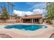 Lush backyard featuring a sparkling pool and a covered patio, a haven for relaxation and outdoor gatherings at 14404 N 56Th Pl, Scottsdale, AZ 85254