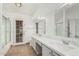 Bathroom featuring double sinks with marble countertops and a framed glass shower at 14404 N 56Th Pl, Scottsdale, AZ 85254