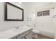 Bathroom with stylish vanity, framed mirror, and a shower-tub combo, offering functionality and modern design at 14404 N 56Th Pl, Scottsdale, AZ 85254