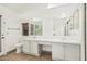 Bright bathroom with double sinks, marble countertops, and a framed shower with neutral tile at 14404 N 56Th Pl, Scottsdale, AZ 85254