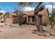 Single-story home featuring desert landscaping, a two-car garage, and a terracotta tiled roof at 14404 N 56Th Pl, Scottsdale, AZ 85254