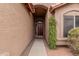 Inviting front entrance featuring a decorative wood door with glass inserts and desert landscaping at 14404 N 56Th Pl, Scottsdale, AZ 85254