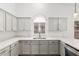 This is the kitchen with white cabinets and updated countertops at 14404 N 56Th Pl, Scottsdale, AZ 85254