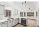 Open kitchen with white cabinets and stainless steel dishwasher at 14404 N 56Th Pl, Scottsdale, AZ 85254