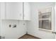 This laundry room features overhead cabinets for storage and a window for natural light at 14404 N 56Th Pl, Scottsdale, AZ 85254