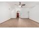 Spacious living room with tile flooring and a ceiling fan at 14404 N 56Th Pl, Scottsdale, AZ 85254