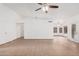 Bright living room with tile flooring, a ceiling fan, and views into other living spaces at 14404 N 56Th Pl, Scottsdale, AZ 85254