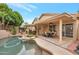 Inviting backyard with a sparkling pool, covered patio, and comfortable outdoor seating at 14447 N 100Th Way, Scottsdale, AZ 85260