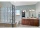 Updated bathroom featuring a glass block shower, double vanity, and modern fixtures at 14447 N 100Th Way, Scottsdale, AZ 85260