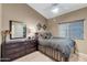 Well-lit bedroom featuring a ceiling fan, neutral colors, and a dresser with a mirror at 14447 N 100Th Way, Scottsdale, AZ 85260