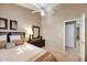 Comfortable bedroom with neutral tones, ceiling fan, and closet access at 14447 N 100Th Way, Scottsdale, AZ 85260