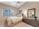 Cozy bedroom with neutral decor, ceiling fan, and natural light from the window at 14447 N 100Th Way, Scottsdale, AZ 85260