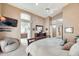 Spacious bedroom with neutral tones, ceiling fan, TV, and ensuite bathroom access at 14447 N 100Th Way, Scottsdale, AZ 85260