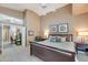 Comfortable bedroom with ceiling fan, neutral colors, and doorway to an office space at 14447 N 100Th Way, Scottsdale, AZ 85260