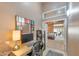 Bright office featuring a desk, a colorful mirror, and an open view to the primary bedroom at 14447 N 100Th Way, Scottsdale, AZ 85260