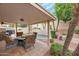 Relaxing patio area featuring a fire pit, comfortable seating, and a scenic garden view at 14447 N 100Th Way, Scottsdale, AZ 85260