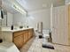 Bright bathroom featuring a double sink vanity with framed mirror and standard toilet at 14545 S Cherry Hills Dr, Arizona City, AZ 85123