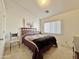 Vaulted-ceiling bedroom featuring a cozy chair and abundant natural light at 14545 S Cherry Hills Dr, Arizona City, AZ 85123