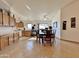 Open-concept dining room featuring tile flooring, ceiling fan, and natural light from the adjacent kitchen and outdoor access at 14545 S Cherry Hills Dr, Arizona City, AZ 85123