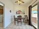 Cozy dining area featuring tile floors, wood furniture, and a sliding door to the outside patio at 14545 S Cherry Hills Dr, Arizona City, AZ 85123