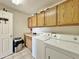 Well-equipped laundry room with ample cabinet space and modern washer and dryer units at 14545 S Cherry Hills Dr, Arizona City, AZ 85123