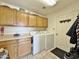 Well-equipped laundry room with ample cabinet space and modern washer and dryer units at 14545 S Cherry Hills Dr, Arizona City, AZ 85123