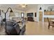 Comfortable living area featuring tile floors, ceiling fan, and views to the kitchen at 14545 S Cherry Hills Dr, Arizona City, AZ 85123