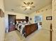 Spacious main bedroom featuring vaulted ceilings, a ceiling fan, and an en-suite bathroom with a soaking tub at 14545 S Cherry Hills Dr, Arizona City, AZ 85123