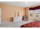 Charming bedroom featuring neutral walls, comfortable chair, and view of the neighborhood outside at 15924 W Falcon Ridge Dr, Sun City West, AZ 85375