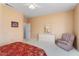 Cozy bedroom with neutral walls, ceiling fan, and comfortable armchair, creating a relaxing retreat at 15924 W Falcon Ridge Dr, Sun City West, AZ 85375