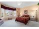 Inviting main bedroom featuring a ceiling fan, carpet, and a large window for plenty of natural light at 15924 W Falcon Ridge Dr, Sun City West, AZ 85375