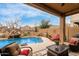 Inviting backyard pool with a rock waterfall feature and comfortable outdoor seating for relaxation at 16830 S Coleman St, Phoenix, AZ 85045