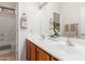 Bathroom with a double sink vanity, white countertops, wood cabinets, and a shower-tub combination at 16830 S Coleman St, Phoenix, AZ 85045