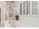 Modern bathroom featuring a luxurious soaking tub and a separate glass-enclosed shower at 16830 S Coleman St, Phoenix, AZ 85045