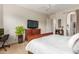 Well-lit bedroom features a dresser, TV, and neutral color palette at 16830 S Coleman St, Phoenix, AZ 85045