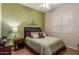 Cozy bedroom featuring a queen-sized bed, decorative wall art, and shuttered windows for natural light at 16830 S Coleman St, Phoenix, AZ 85045