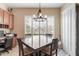 Cozy dining area with natural light, a chandelier, and views of the desert landscape at 16830 S Coleman St, Phoenix, AZ 85045