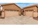 View of the house showing the side by side garages and large driveway at 16830 S Coleman St, Phoenix, AZ 85045