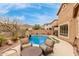 Outdoor seating area with a view of the pool and rock waterfall, ideal for relaxing in the serene backyard setting at 16830 S Coleman St, Phoenix, AZ 85045