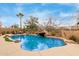 Sparkling pool featuring a rock waterfall and mature desert landscaping, creating a private backyard oasis at 16830 S Coleman St, Phoenix, AZ 85045