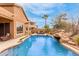 Stunning backyard pool with a rock waterfall feature, perfect for enjoying the outdoors and entertaining guests at 16830 S Coleman St, Phoenix, AZ 85045